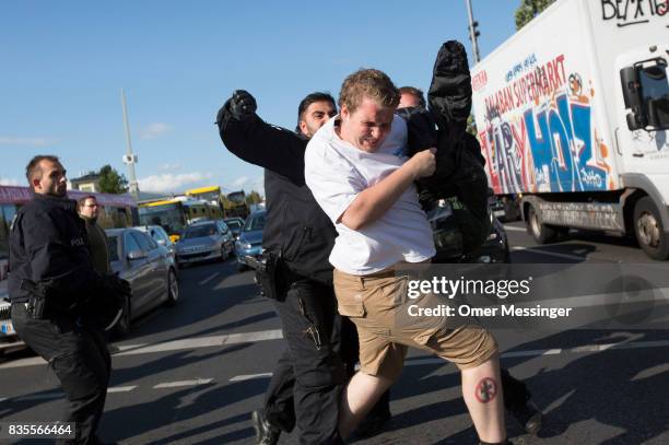 German policeman arrest a participant of a Neo-Nazi march, after a fight that broke out with fascists in the end of the march as the two sides were...