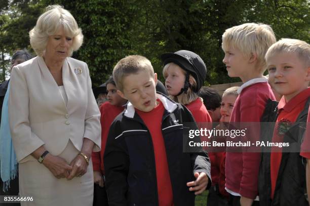 The Duchess of Cornwall with children from All Saints school in Dulverton, during her visit to the Exmoor Pony Centre in Exmoor, Somerset.