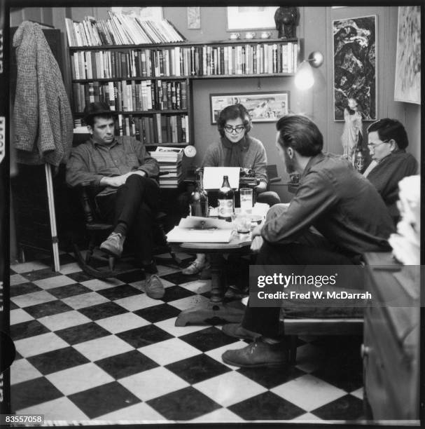 American writers Jack Kerouac , Albert Saijo , and Lew Welch sit around a low table as they collaborate on a poem, which is typed by Gloria Schoffel...