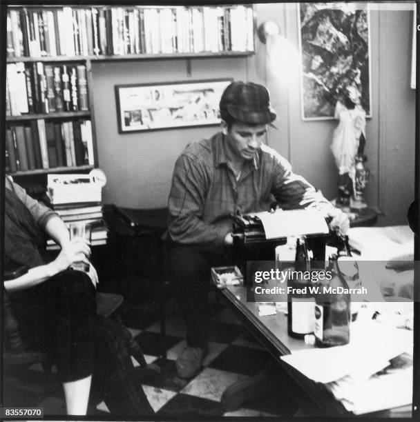 American author and poet Jack Kerouac types a poem at the apartment of photographer McDarrah and his soon-to-be wife, Gloria , New York, New York,...