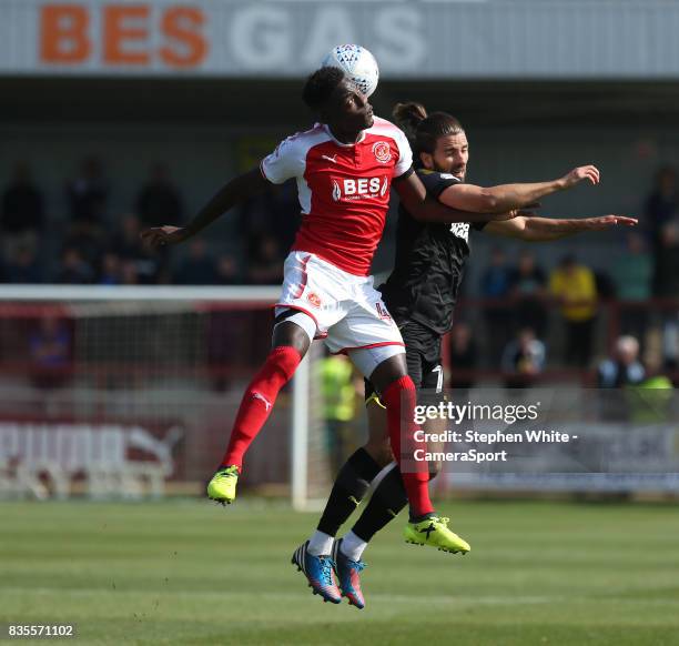 Fleetwood Town's Devante Cole and AFC Wimbledon's George Francomb during the Sky Bet League One match between Fleetwood Town and A.F.C. Wimbledon at...