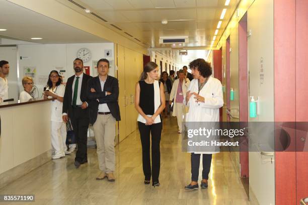 In this handout photo provided by Casa de S.M. El Rey de Espana, King Felipe VI of Spain and Queen Letizia of Spain meets with medical staff as they...