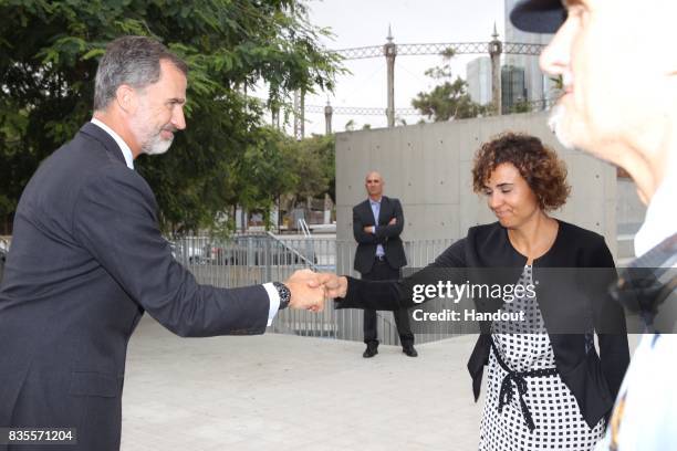 In this handout photo provided by Casa de S.M. El Rey de Espana, King Felipe VI of Spain meets with medical staff as they arrive to visit last...