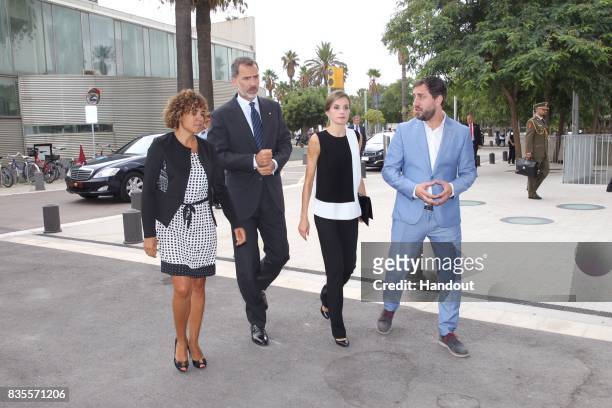 In this handout photo provided by Casa de S.M. El Rey de Espana, King Felipe VI of Spain and Queen Letizia of Spain meets with medical staff as they...