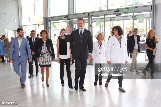 In this handout photo provided by Casa de S.M. El Rey de Espana, King Felipe VI of Spain and Queen Letizia of Spain meets with medical staff as they...