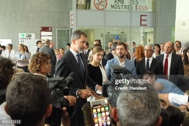 In this handout photo provided by Casa de S.M. El Rey de Espana, King Felipe VI of Spain and Queen Letizia of Spain speak to the media and meet with...