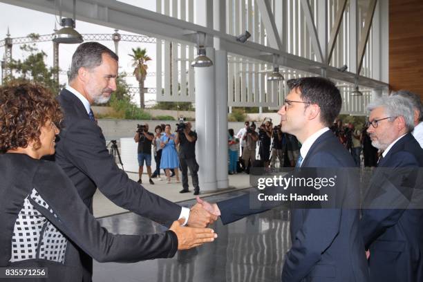 In this handout photo provided by Casa de S.M. El Rey de Espana, King Felipe VI of Spain and Queen Letizia of Spain meets with medical staff as they...