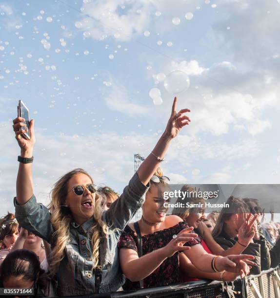 Festival goers enjoy the music during V Festival 2017 at Hylands Park on August 19, 2017 in Chelmsford, England.