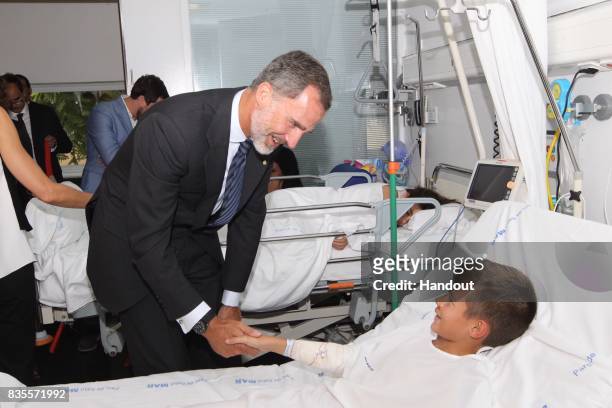In this handout photo provided by Casa de S.M. El Rey de Espana, King Felipe VI of Spain visits a victim of last Thursday's terrorist attack at the...