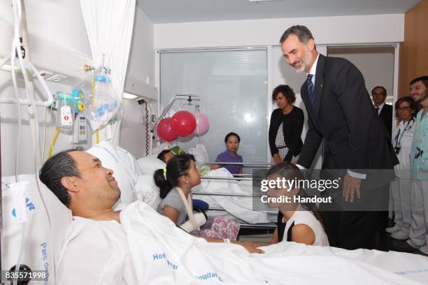 In this handout photo provided by Casa de S.M. El Rey de Espana, King Felipe VI of Spain and Queen Letizia of Spain visits victims of last Thursday's...