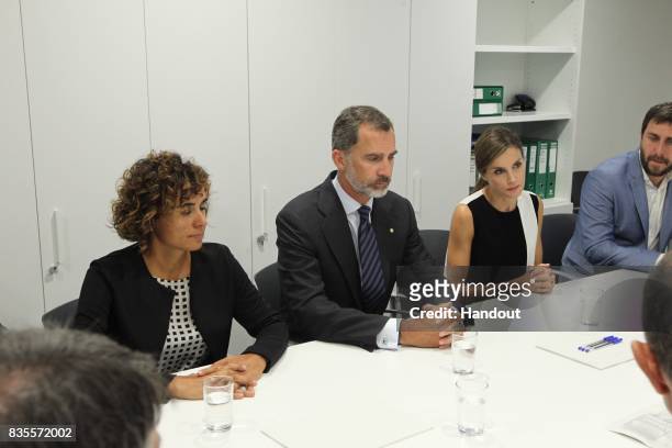 In this handout photo provided by Casa de S.M. El Rey de Espana, King Felipe VI of Spain and Queen Letizia of Spain meets with medical staff before...