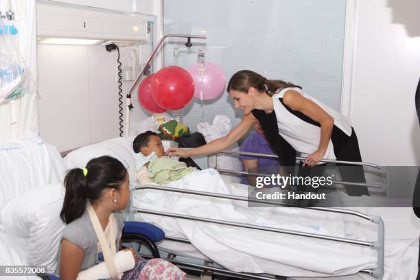 In this handout photo provided by Casa de S.M. El Rey de Espana, Queen Letizia of Spain visits victims of last Thursday's terrorist attack at the...