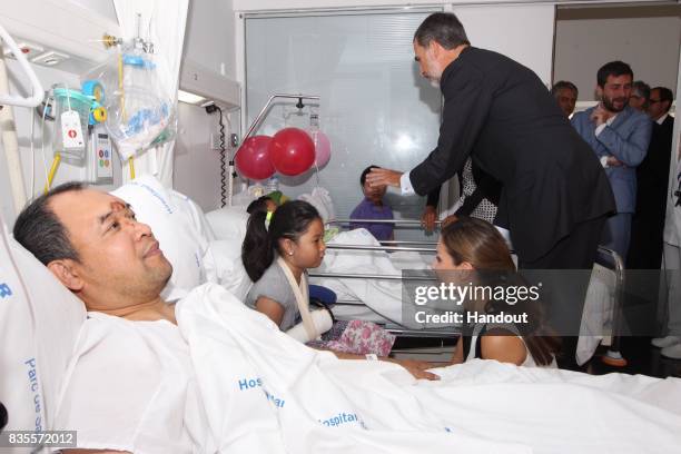 In this handout photo provided by Casa de S.M. El Rey de Espana, King Felipe VI of Spain and Queen Letizia of Spain visits victims of last Thursday's...