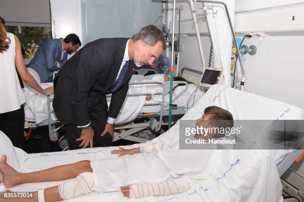In this handout photo provided by Casa de S.M. El Rey de Espana, King Felipe VI of Spain visits a victim of last Thursday's terrorist attack at the...
