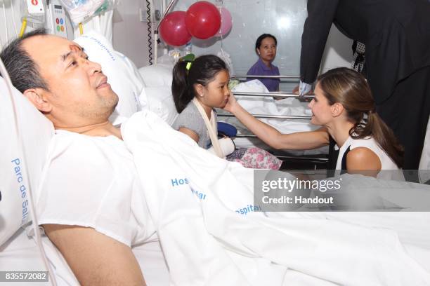 In this handout photo provided by Casa de S.M. El Rey de Espana, Queen Letizia of Spain visits victims of last Thursday's terrorist attack at the...