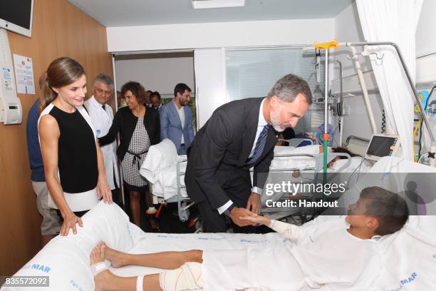 In this handout photo provided by Casa de S.M. El Rey de Espana, King Felipe VI of Spain and Queen Letizia of Spain visits a victim of last...