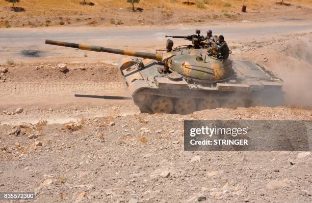 Syrian pro-government forces tank is seen in the Salamiyah city, some 33 kilometres southeast of Hama, on August 19 during an offensive against...