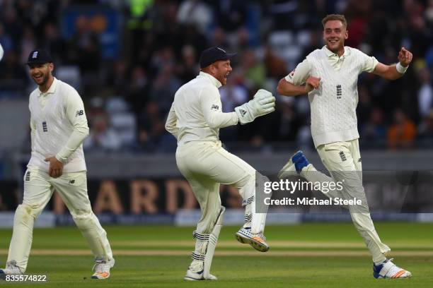 Stuart Broad of England celebrates with Jonny Bairstow after capturing the wicket of Jason Holder during day three of the 1st Investec Test match...