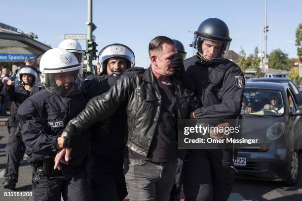 German policeman arrest a participant of a Neo-Nazi march after a fight that broke out at the end of the march as people were dispersing, on August...