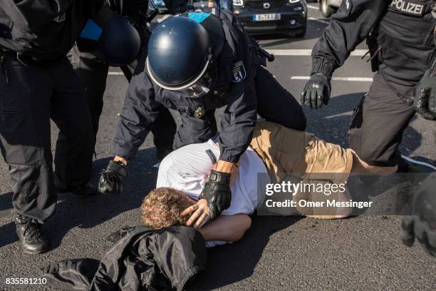 German policeman arrest a participant of a Neo-Nazi march after a fight that broke out at the end of the march as people were dispersing, on August...