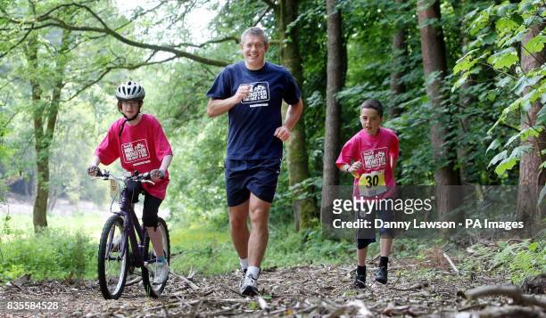 Former international rugby star Gavin Hastings warms up with brother and sister Ross and Kerry Docherty ahead of the Mini Monster Challenge in Pollok...