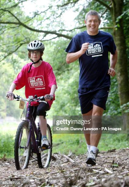 Former international rugby star Gavin Hastings warms up with Kerry Docherty ahead of the Mini Monster Challenge in Pollok Park, Glasgow.