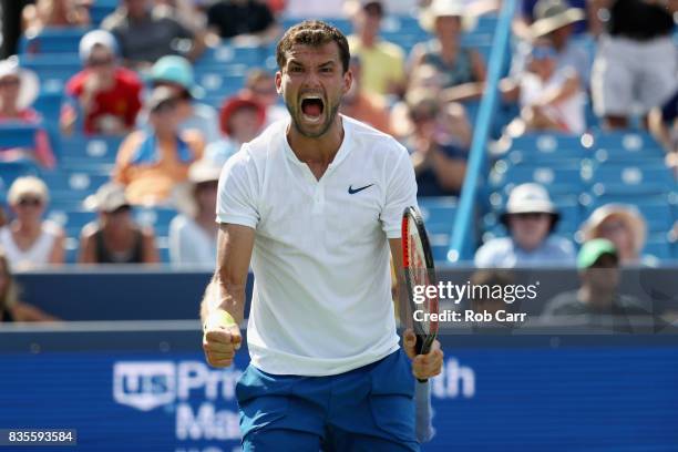 Grigor Dimitrov of Bulgaria celebrates after defeating John Isner to advance to the finals during Day 8 of the Western and Southern Open at the...