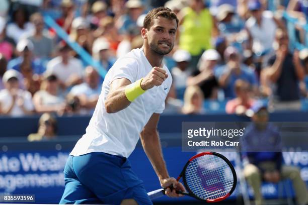 Grigor Dimitrov of Bulgaria celebrates after defeating John Isner to advance to the finals during Day 8 of the Western and Southern Open at the...