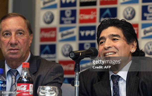 Argentinian football legend Diego Maradona speaks next to 1986 World Cup winning coach Carlos Bilardo after being officially appointed national team...