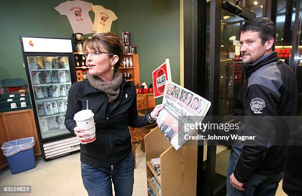 Republican vice-presidential nominee Alaska Gov. Sarah Palin and her husband Todd Palin react to an Anchorage Daily News front page headline reading...