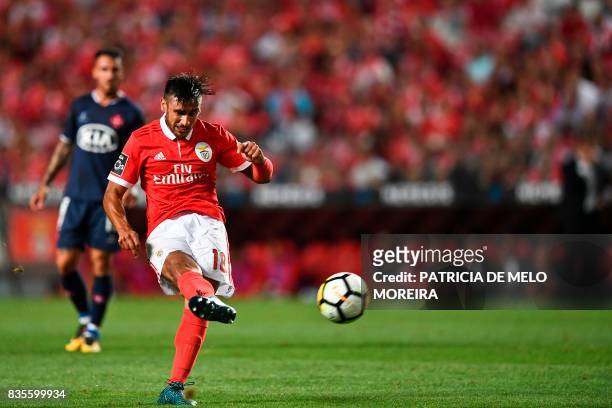 Benfica's Argentine midfielder Eduardo Salvio kicks the ball to score during the Portuguese League football match SL Benfica vs Os Belenenses at Luz...