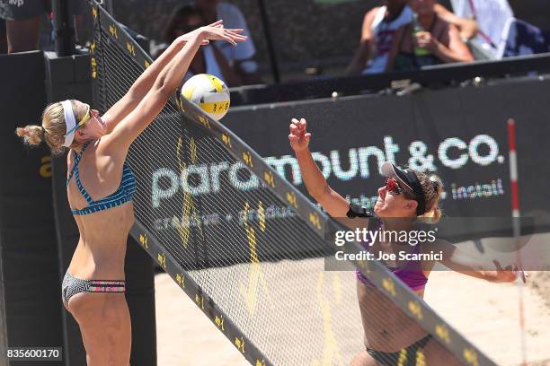 Summer and April Ross jump at the net during their round 4 match at the AVP Manhattan Beach Open - Day 3 on August 19, 2017 in Manhattan Beach,...