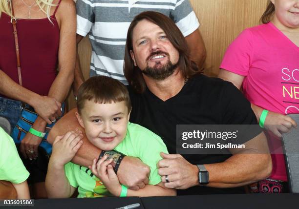 Superstar A.J. Styles poses with a wish kid at the WWE Superstars Surprise Make-A-Wish Families at One World Observatory on August 19, 2017 in New...