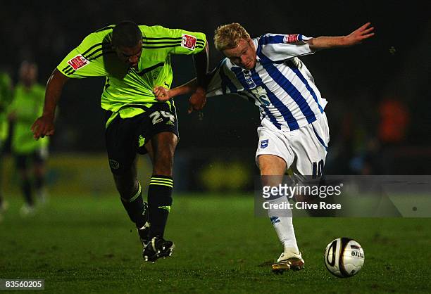 Kevin Thornton of Brighton and Hove Albion is challenged by Miles Addison of Derby during the Carling Cup Third Round match between Brighton and Hove...
