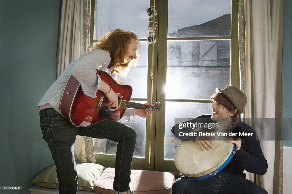 Two friends making music.