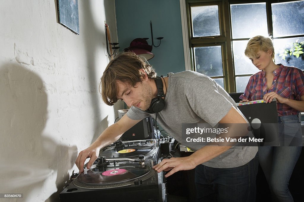 Couple playing vinyl records.