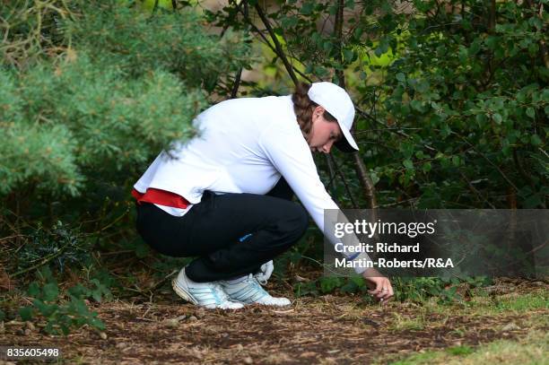 Lily May Humphreys of England checks her lie on the 7th hole during her semi-final match against Paula Kimer of Germany during the Girls' British...