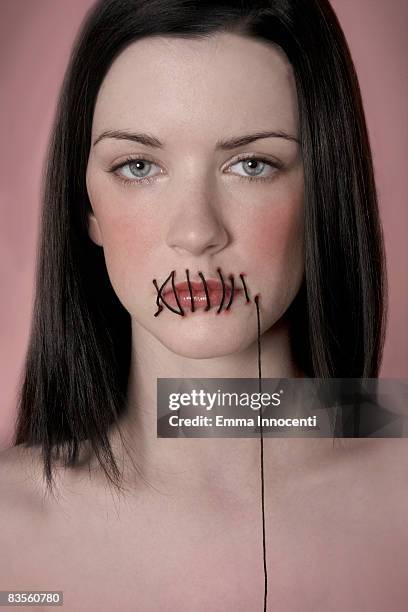 woman's lips stitched up - schocktaktik stock-fotos und bilder