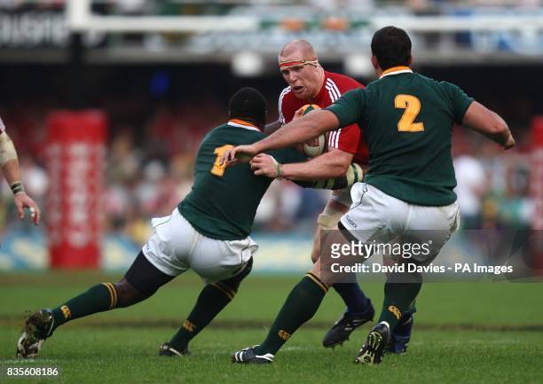 British and Irish Lions' captain Paul O'Connell is tackled by South Africa's Tendai Mtawarira and Bismarck du Plessis m