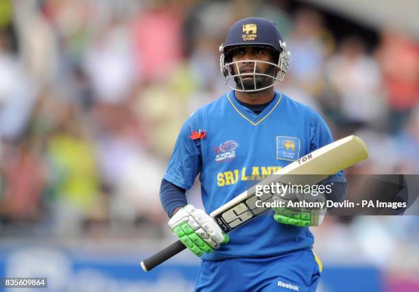 Sri Lanka's Chamara Silva leaves the field after being caught by Pakistan's Saeed Amjal off the bowling of Umar Gul during the Final of the ICC World...