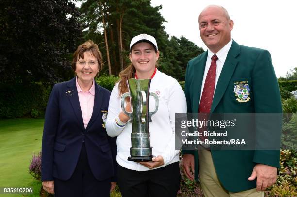 Lily May Humphreys of England poses with the trophy and the Enville Golf Club Captains following her victory during the final of the Girls' British...