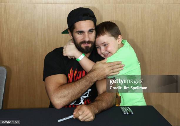 Superstar Seth Rollins poses with a wish kid at the WWE Superstars Surprise Make-A-Wish Families at One World Observatory on August 19, 2017 in New...