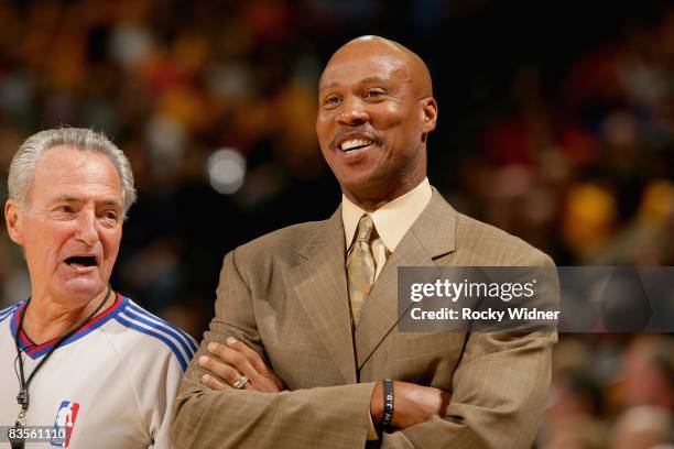 Head coach Byron Scott of the New Orleans Hornets shares a laugh with referee Jack Nies during the game against the Golden State Warriors on October...
