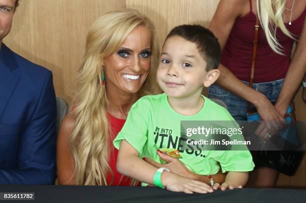 Dana Warrior poses with a wish kid at the WWE Superstars Surprise Make-A-Wish Families at One World Observatory on August 19, 2017 in New York City.