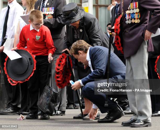 Comic actor Eddie Izzard, helps Peggie Jefferson from Grimsby, whose husband Roland, was a Normandy Veterans Association founder member, while...