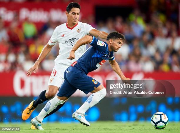 Pablo Piatti of RCD Espanyol being followed by Paulo Henrique Ganso of Sevilla FC during the La Liga match between Sevilla and Espanyol at Estadio...