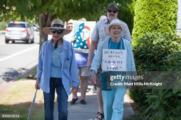 Demonstrators walk along the sidewalk outside of Google's offices during an anti-Trump protest on August 19, 2017 in Kirkland, Washington. The...