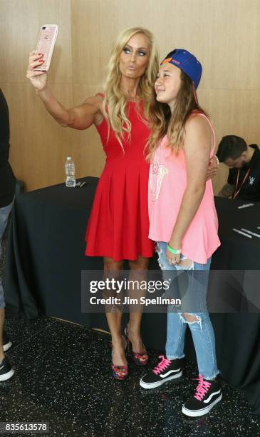 Dana Warrior poses with a wish kid at the WWE Superstars Surprise Make-A-Wish Families at One World Observatory on August 19, 2017 in New York City.