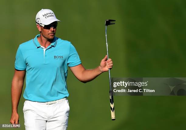 Henrik Stenson of Sweden reacts as he walks up to the 18th green during the third round of the Wyndham Championship at Sedgefield Country Club on...