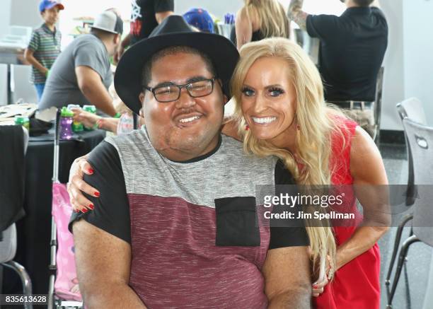Dana Warrior poses with a wish kid at the WWE Superstars Surprise Make-A-Wish Families at One World Observatory on August 19, 2017 in New York City.